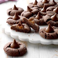 chocolate cookies are arranged on a white platter