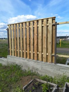 a wooden fence sitting next to a field