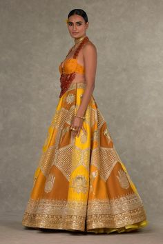 Ochre lehenga with separate cancan skirt, adorned with Son-chidiya, Neel-Kamal, Haathphool and Jaali motif and embroidered in dori, sitara and moti kaam. Paired with digital printed padded bustier and stone drops embellishment. Comes with Neel-Kamal embroidered dupatta all over in dori, sitara and moti kaam embellished with embroidred border.
Components: 4
Pattern: Embellished, Embroidery
Type Of Work: Dori, sitara kaam, moti, stone
Neckline: Halter neck
Sleeve Type: Sleeveless
Fabric: Lehenga a Can Can Skirt, Cancan Skirt, Embellished Embroidery, Caribbean Fashion, Yellow Lehenga, Embroidered Dupatta, Lakme Fashion Week, Can Can, Fitted Blouses