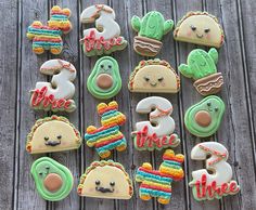 decorated cookies are arranged on a wooden table