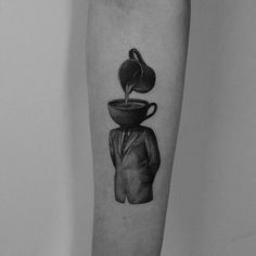 a black and white photo of a man's leg with a coffee pot pouring out of it