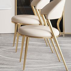 three chairs with gold legs and white upholstered seats in front of a mirror