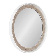 a round mirror with wood trim around the edges and a white frame, on a white wall