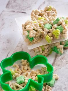 lucky krispie treats are sitting on top of each other with shamrock shaped cookie cutters