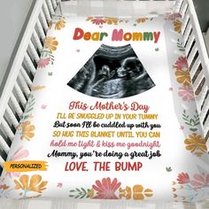 a baby crib with a sheet that says dear mommy