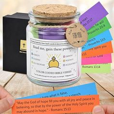 a jar filled with lots of different colored paper next to a small card that says god's good bible verse