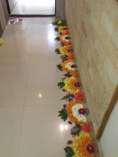 flowers are laid out on the floor in front of a wall