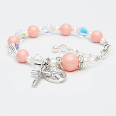 Made with genuine Swarovski crystals and pearls throughout. No seed beads. Please let me know the date of the event along with personalization details, if applicable, in the notes box at checkout. Celebrate the Baptism of a baby girl with this beautiful Swarovski crystal rosary bracelet featuring light coral Swarovski pearls and sparkly clear diamond-shaped crystals. The bracelet may be personalized with one single letter if you choose. Please choose between one sterling silver letter bead, one Adjustable Pink Rosary Bracelet For First Communion, Pink Beaded Jewelry For First Communion, Elegant Pink Bracelets For First Communion, Adjustable Rosary Bracelet With Round Beads For Baptism, Pink Beaded Jewelry For Baptism, Adjustable 8mm Beads Rosary Bracelet For Baptism, Pink Spiritual Jewelry For First Communion, Baby Girl Baptism Gift, Crystal Rosary