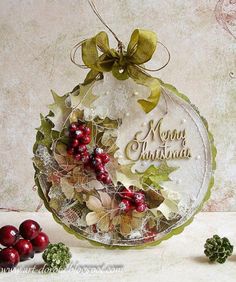 a christmas ornament with holly and berries on it