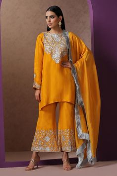 Mustard straight kurta with placement kashmiri tilla embroidery. Paired with a bell bottom pant with placement kashmiri tilla work. Comes along with a zari fringed dupatta.
Components: 3
Pattern: Embroidery
Type Of Work: Kashmiri Tilla
Neckline: Round Neck
Sleeve Type: Full Sleeves
Fabric: Silk, Organza, Lining: Cotton
Color: Yellow
Other Details: 
Length:
Kurta: 35 inches
Bell Bottom Pant: 38 inches
Approx. product weight: 1 kg
Model height: 5ft 7inches, wearing size S
Inner lining
Occasion: Sa Luxury Long Sleeve Churidar For Puja, Kashmiri Work Suits, Tilla Work Embroidery Suits, Kashmiri Embroidery Suits, Yellow Lehenga For Haldi, Gota Patti Suits, Tilla Embroidery, Punjabi Suit Boutique, Salwar Kameez Online Shopping