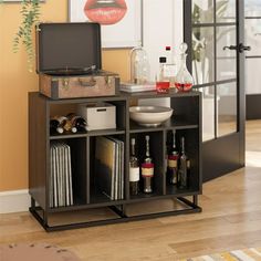 an entertainment center with wine bottles and liquor