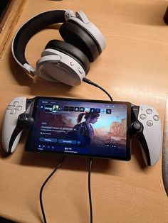 an image of a tablet with headphones on it and a game controller next to it