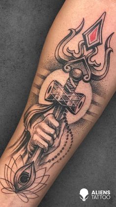 a tattoo on the arm of a person holding a hammer