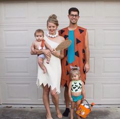 a man, woman and child are dressed up as the flintman and his wife