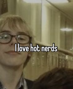 a man with glasses standing in front of a mirror that says i love hot nerds