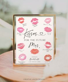 a sign that says kisses for the future mrs on top of a wooden table with pink lipstick