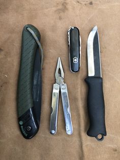 several different types of knifes and knives on a table with one opened, the other closed