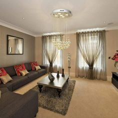 a living room with two couches, a coffee table and a chandelier