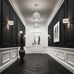 an empty hallway with black and white walls