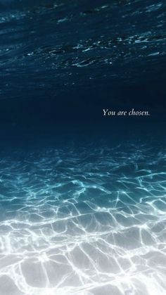 the water is very clear and blue with an inspirational quote on it that says you are chosen