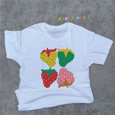 This Stages Of Strawberry Tee is a cottagecore shirt that was inspired by kidcore shirt and kidcore clothes. With eye catching colors - this strawberry shirt will surely be a great staple for your cottagecore aesthetic or kidcore aesthetic wardrobe. It can be a cute gift for her, cute gift for him or anyone in between as this strawberry printed shirts are unisex. Available in Sizes XS, S, M, L, XL, 2XL and 3XL. *Order the next size or size after next for oversized shirt comfy look. ✨ MilkDesigns Original ✨ 100% ⭐️ PREMIUM ⭐️ Airlume combed and ringspun cotton  ✨ Light fabric ✨ Retail Unisex fit ✨ Tear away label ✨ Runs true to size ‼️ Print Size will scale up or down depending on the shirt size to keep the integrity of the print. *Sustainability Commitment: All of our products are made onl Cute Multicolor Printed Shirt, Vintage Cotton Tops With Fruit Print, White Cotton Shirt With Fruit Print, Playful White Tops With Strawberry Print, Cute Multicolor Screen Print Shirt, Kidcore Shirt, Kidcore Clothes, Kidcore Clothing, Aesthetic Wardrobe