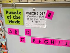 a bulletin board with pink and green sticky notes attached to it's side, which reads puzzle of the week on which side?