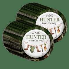 three buttons with words on them that say, a little hunter is on the way