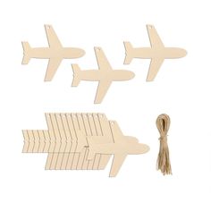 three wooden cutouts with an arrow and plane on the bottom one has a tassel attached to it