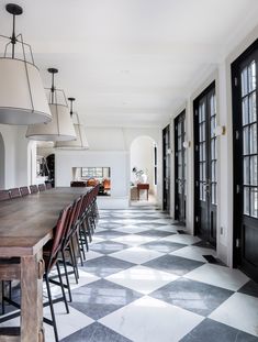 a large dining room with black and white checkered flooring