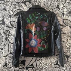 This is an original hand painted wearable item. I  painted the jacket using Angelus Acrylic Leather paint and and acrylic marker. I added a layer of acrylic finisher to protect the painting.  Jacket info: - This is a Zenana faux Leather Jacket - Size M One of a kind piece! If you need any info, including any specific measurement, send me a note! Artistic Hand Painted Outerwear For Fall, Hand Painted Multicolor Outerwear For Fall, Multicolor Hand Painted Outerwear For Fall, Black Hand Painted Long Sleeve Outerwear, Colorful Jacket, Embellished Denim Jacket, Leather Paint, Leather Baby, Embellished Denim