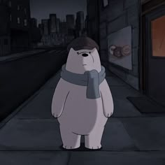 a large white bear standing on top of a sidewalk next to a building at night