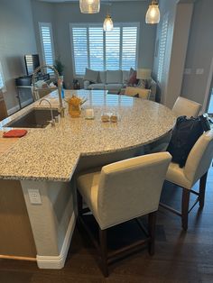 a large kitchen island with chairs around it