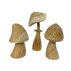 three wooden mushrooms are shown on a white background