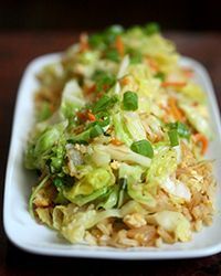 a white plate topped with rice and vegetables