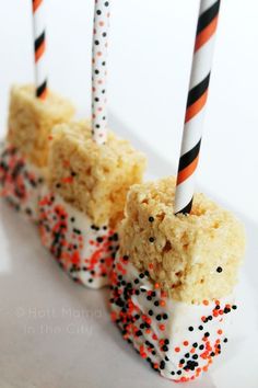 cake pops with sprinkles and candles on a white plate