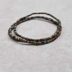 These are size 11/0 beautiful Czech Tropical Picasso stretch seed bead bracelets!  You'll receive 3 bracelets per transaction!  These seed beads are size 11/0 so they're super tiny, and the beautiful colors of the seed beads I use are stunning! If you're unfamiliar with the size "11/0" the hole is the size of a needle point! (11/0 seed beads are 2mm by 2mm with the hole a diameter of 1mm.) Stretch seed bead bracelets are made on elastic cord, so these bracelets stretch then slide over your hand! It's your choice of how you'd like your bracelets to fit based on your wrist size, and the size options given! (Please measure your wrist accordingly!) Your bracelets will come shipped in an organza drawstring pouch! Spiritual Heishi Beads Friendship Bracelets, Adjustable Bracelets With Tiny Oval Beads, Seed Bead Bracelet, Needle Point, Bead Bracelets, Seed Bead Bracelets, Drawstring Pouch, Bead Bracelet, Seed Bead