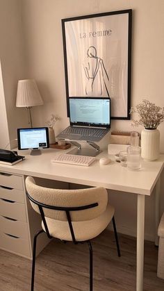 a laptop computer sitting on top of a white desk