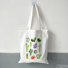 We love a good tote bag. Whether you need to make a quick grocery run or carry some essentials around with you, a tote always comes in handy. These canvas totes feature adorable cactus prints! Whether you love cartoon style, watercolors, or monochromatic, show off your plant parent style with these unique shoulder bags! Made of high-quality canvas, these tote bags will last years to come. As a bonus, they're easily washable! Just throw them in with your regular laundry and air dry! Specification White Casual Canvas Bag, Casual White Rectangular Canvas Bag, Casual White Canvas Bag For Everyday Use, Casual Reusable Canvas Bag For Travel, Casual Reusable Canvas Shopping Bag, Trendy White Reusable Bags, Casual White Reusable Bags, Casual Reusable Tote Bag, Casual Reusable Canvas Bag For Summer