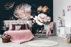 a bedroom with large flowers on the wall