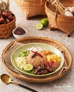 a plate with rice, meat and vegetables on it next to bowls of other foods