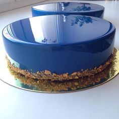 two blue dishes sitting on top of a white counter