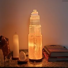 a table topped with candles and books on top of it