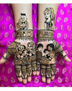 two hands with hendi designs on them, one is holding a child and the other has