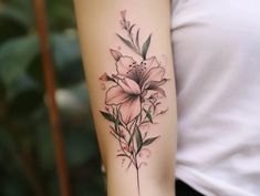 a woman's arm with a flower tattoo on the left side of her arm