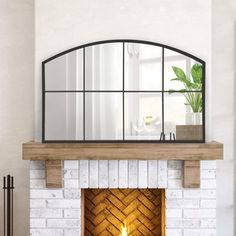 a fireplace with a mirror above it and a potted plant on the mantle in front