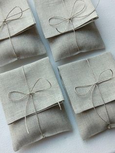 four pieces of linen wrapped in twine and tied with string, sitting next to each other