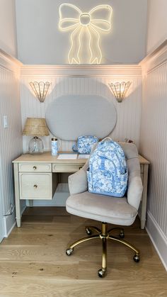 a chair that is sitting in front of a desk with a lamp on top of it