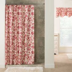 a red and white shower curtain hanging in a bathroom next to a window with curtains on it