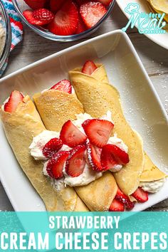 strawberry cream cheese crepes on a plate with strawberries