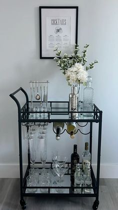 a bar cart filled with glasses and bottles